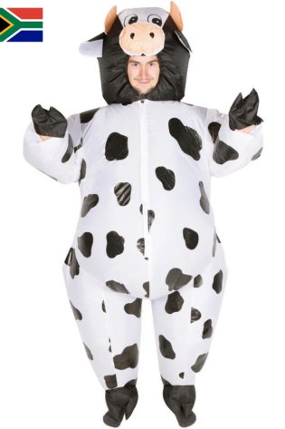 Person wearing a white inflatable cow costume with black spots and cow head hood, smiling at camera in full-body suit.
